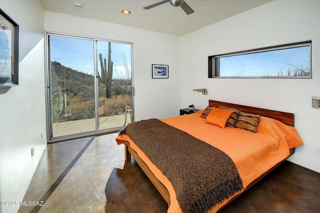 bedroom with access to exterior, recessed lighting, finished concrete floors, and multiple windows