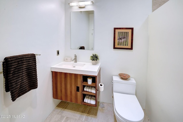 half bathroom with vanity and toilet