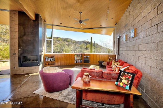 interior space with a ceiling fan, a fireplace, and a mountain view