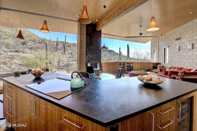 kitchen with brown cabinets, dark countertops, modern cabinets, wooden ceiling, and black electric cooktop