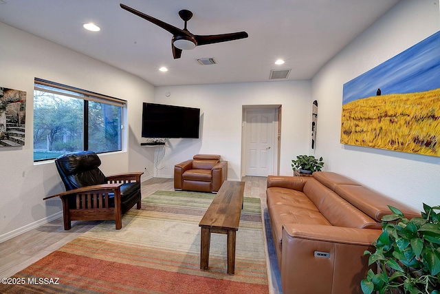 living room with hardwood / wood-style flooring and ceiling fan