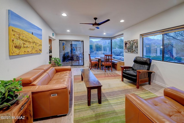 living room with light hardwood / wood-style flooring and ceiling fan