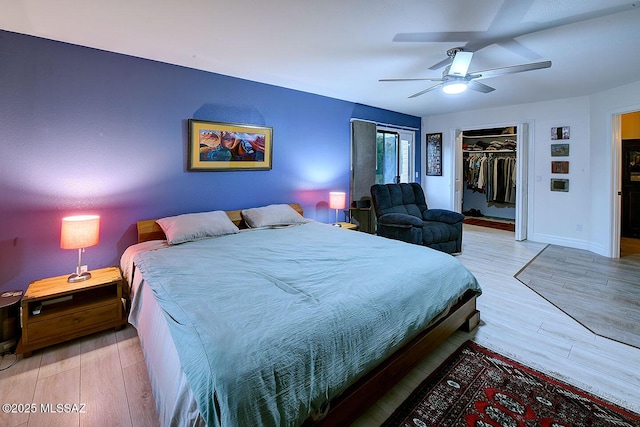 bedroom featuring a closet, ceiling fan, and light wood-type flooring