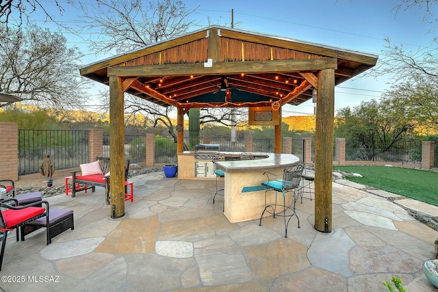 view of patio / terrace featuring a gazebo, area for grilling, grilling area, and an outdoor bar