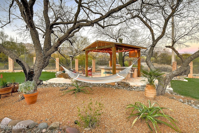 yard at dusk featuring a gazebo