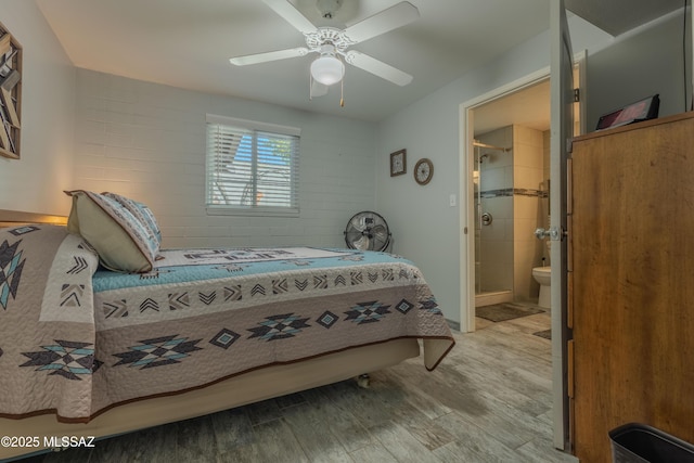 bedroom with ceiling fan, connected bathroom, and wood-type flooring