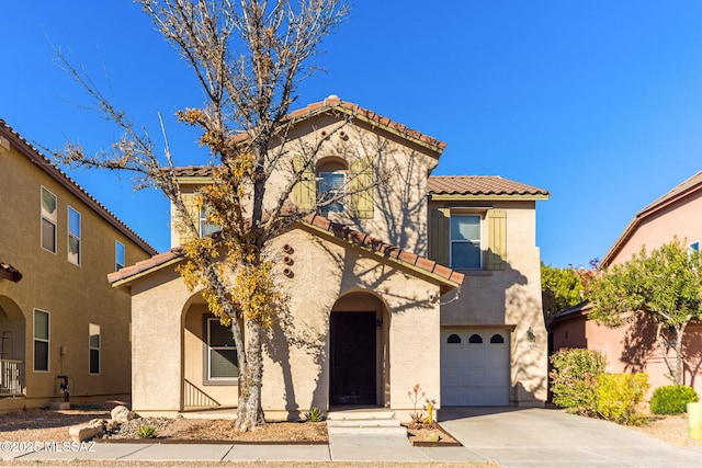 mediterranean / spanish-style home with a garage