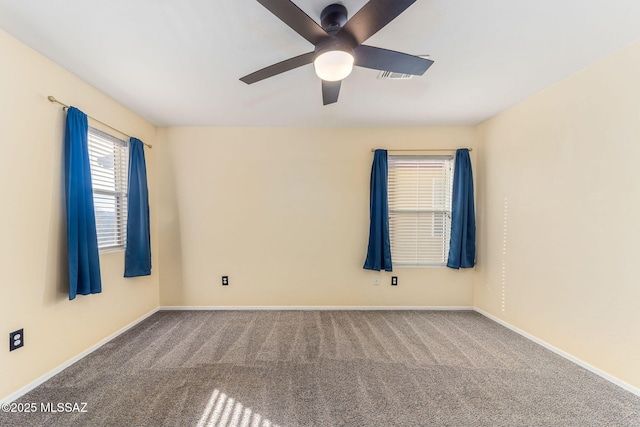 spare room featuring ceiling fan and carpet flooring