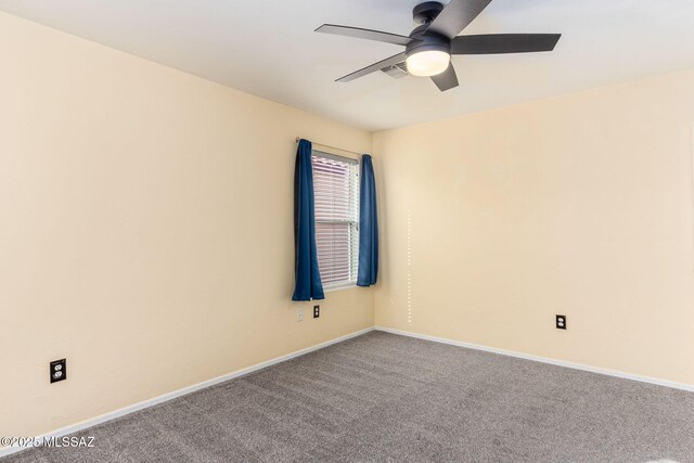 spare room featuring ceiling fan and carpet flooring