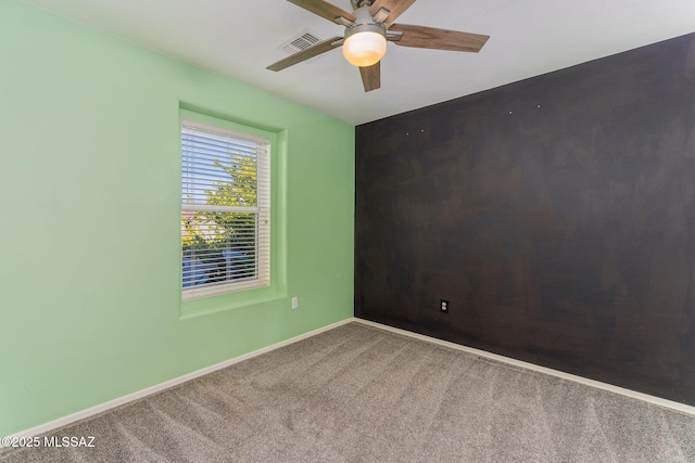 carpeted empty room with ceiling fan