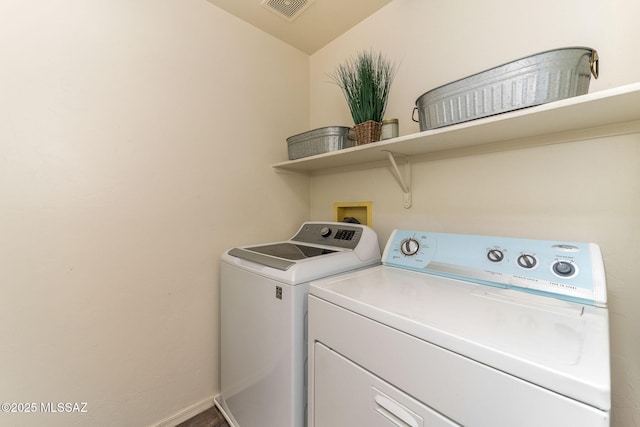 clothes washing area with washer and clothes dryer