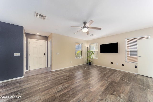 unfurnished living room with ceiling fan and dark wood-type flooring