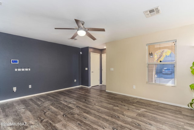 unfurnished room featuring ceiling fan and dark wood-type flooring