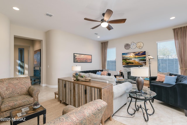 living room featuring plenty of natural light, ceiling fan, recessed lighting, and light tile patterned floors