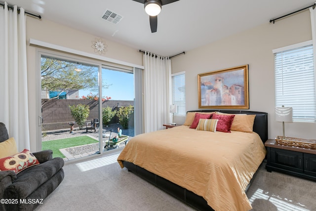 bedroom featuring access to exterior, visible vents, ceiling fan, and carpet