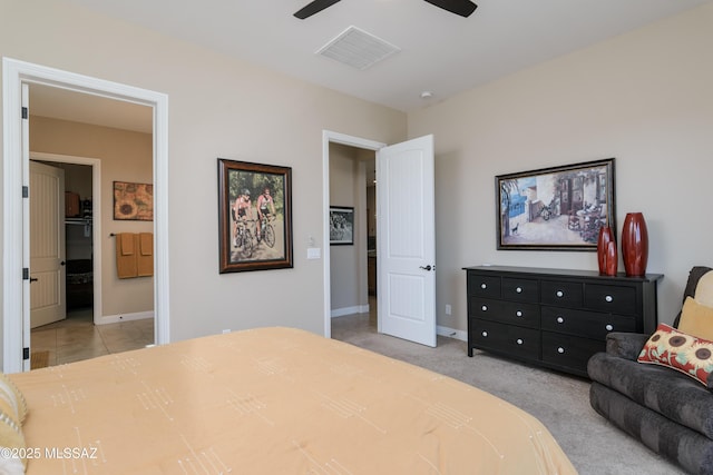 carpeted bedroom featuring baseboards, visible vents, ceiling fan, and ensuite bath