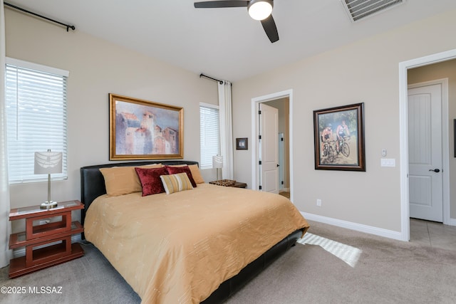 carpeted bedroom featuring a ceiling fan, baseboards, and visible vents