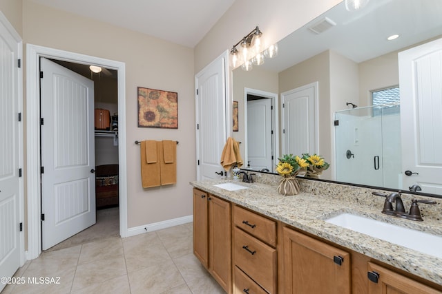 full bath featuring a stall shower, tile patterned floors, visible vents, and a sink