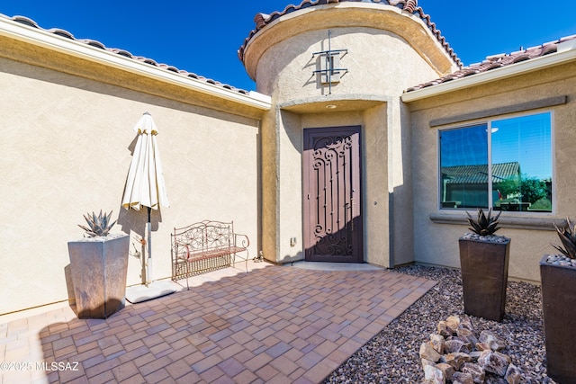 entrance to property with a patio