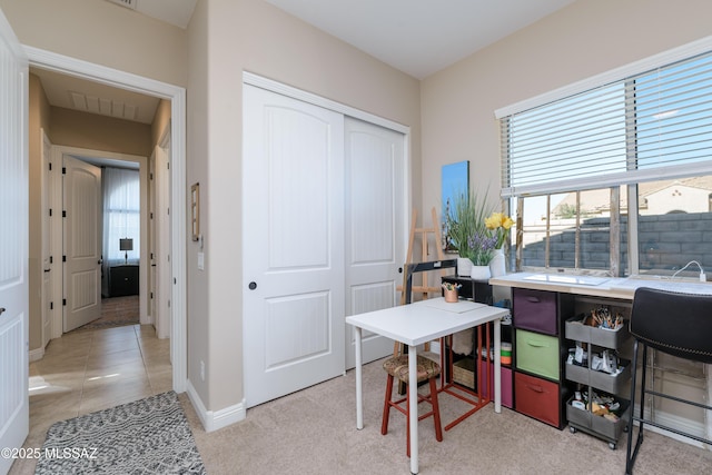 office area with light tile patterned floors and baseboards