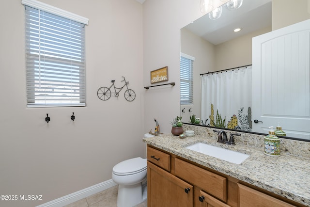 bathroom featuring a wealth of natural light, toilet, tile patterned flooring, and vanity