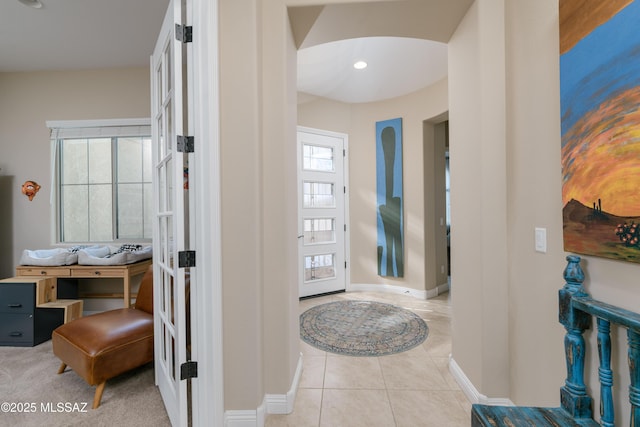 corridor with tile patterned flooring and baseboards