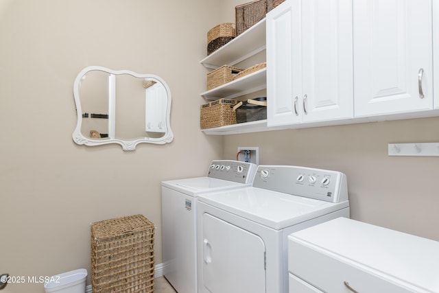 laundry room with washing machine and dryer and cabinet space