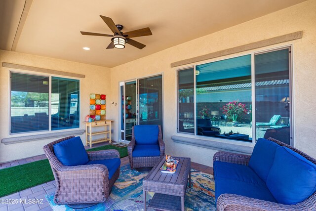 view of patio / terrace with an outdoor living space and ceiling fan