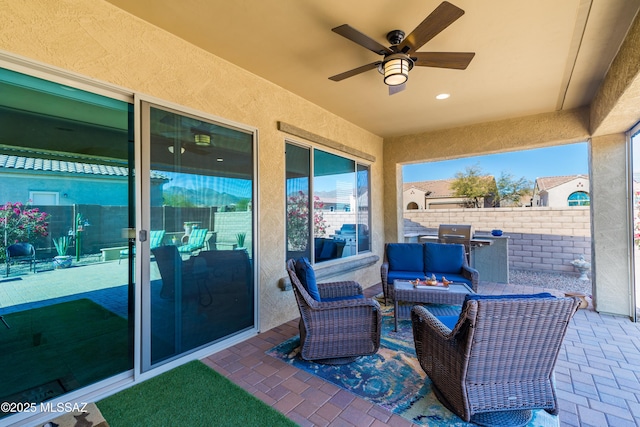 view of patio featuring outdoor lounge area, fence, and a ceiling fan