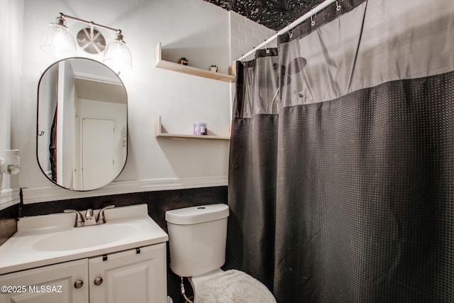 bathroom with vanity, toilet, and curtained shower