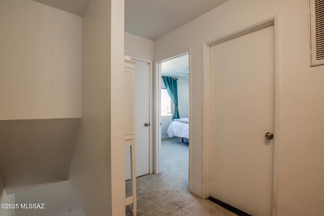 corridor with light colored carpet