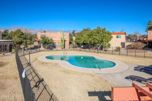 view of swimming pool featuring a patio and a mountain view