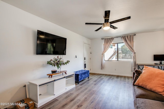 living room with ceiling fan and light wood-type flooring