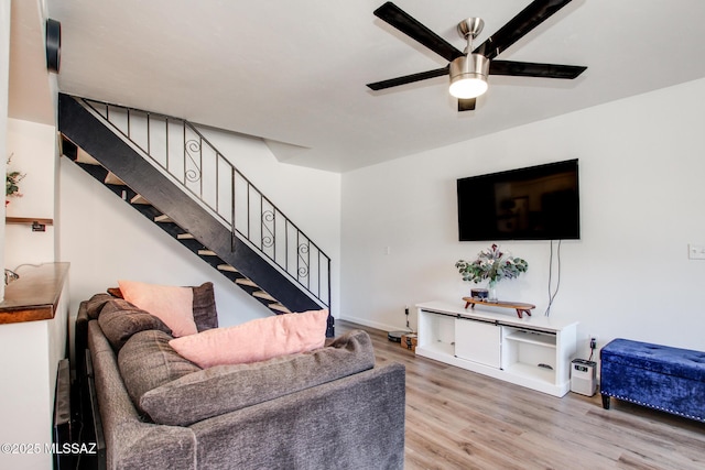 living room featuring hardwood / wood-style floors and ceiling fan