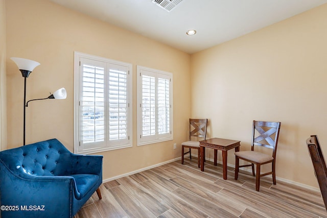 living area with hardwood / wood-style flooring