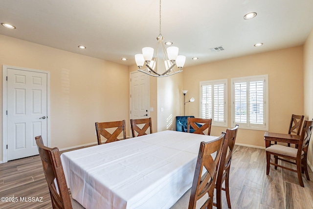 dining room with an inviting chandelier and dark hardwood / wood-style floors