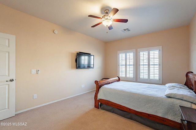 bedroom with ceiling fan and light carpet