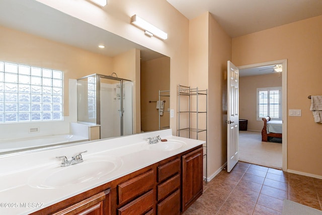 bathroom with an enclosed shower, vanity, and tile patterned floors