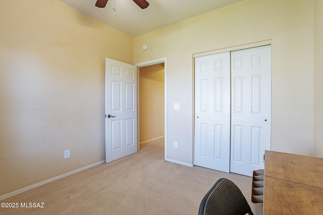 unfurnished bedroom with light carpet, a closet, and ceiling fan