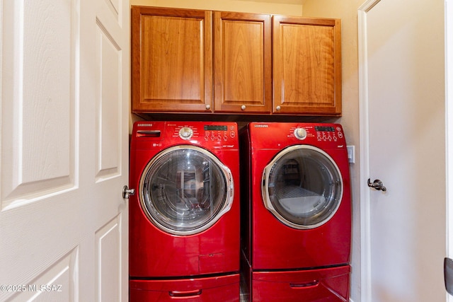 clothes washing area featuring separate washer and dryer and cabinets