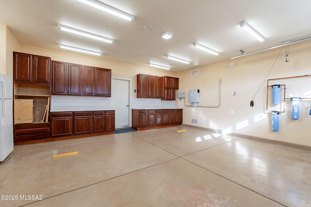 garage featuring white fridge