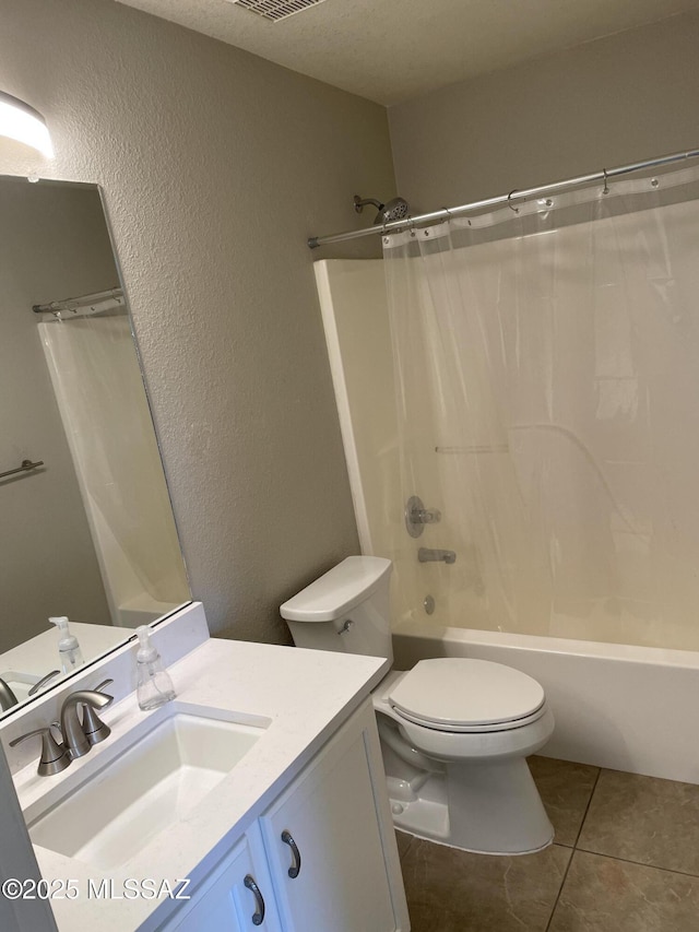 full bathroom with toilet, shower / bath combination with curtain, tile patterned floors, a textured ceiling, and vanity