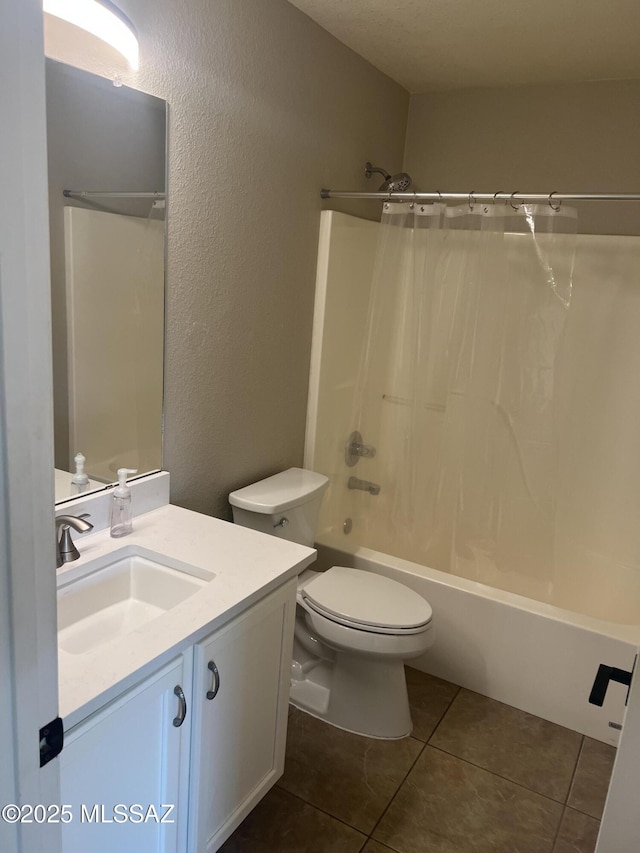 full bathroom featuring toilet, vanity, tile patterned floors, and shower / bath combo