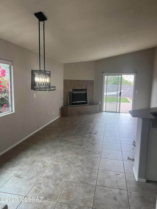 unfurnished living room featuring a tile fireplace