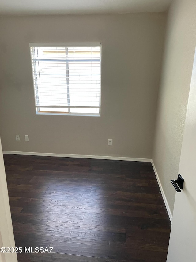 unfurnished room featuring dark wood-type flooring