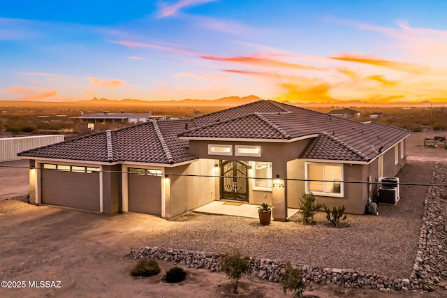 view of front facade with a mountain view and a garage