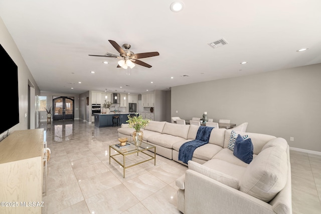 living room with ceiling fan and french doors