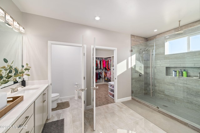 bathroom featuring vanity, toilet, and an enclosed shower