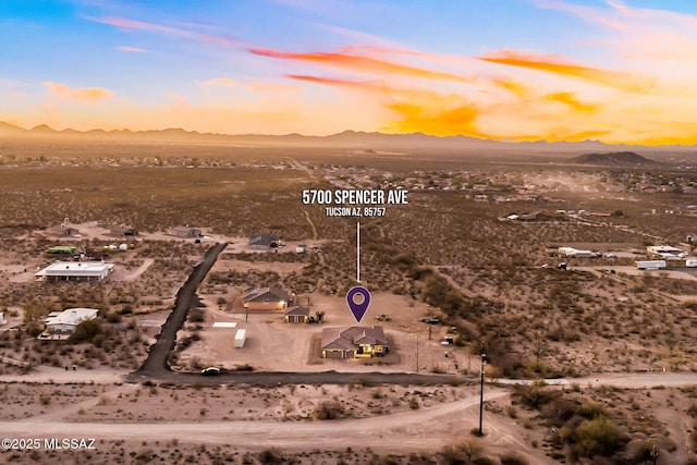 aerial view at dusk featuring a mountain view