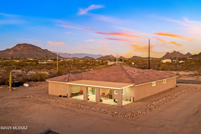 exterior space featuring a mountain view and a patio area